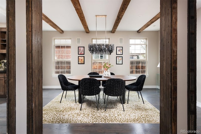 dining space with a wealth of natural light, dark wood-style floors, and baseboards