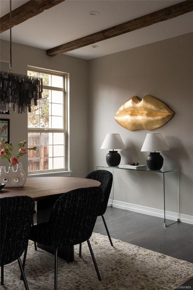 dining room with beamed ceiling, wood finished floors, and baseboards