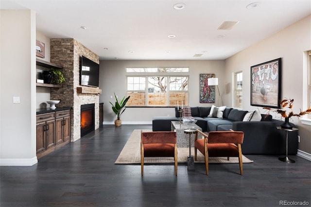 living area with dark wood-style floors, a fireplace, and baseboards