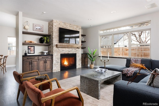 living room with recessed lighting, a fireplace, dark wood-type flooring, and baseboards