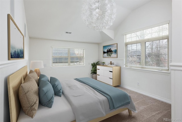 bedroom with multiple windows and a wainscoted wall