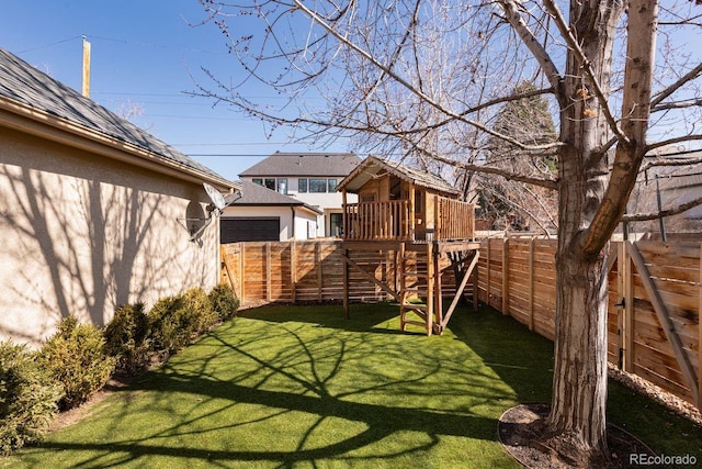 view of yard with a playground and a fenced backyard