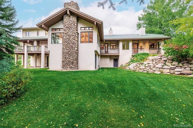 983 Beard Creek Rd, Edwards, CO 81632 - back of house featuring a chimney, stucco siding, and a lawn