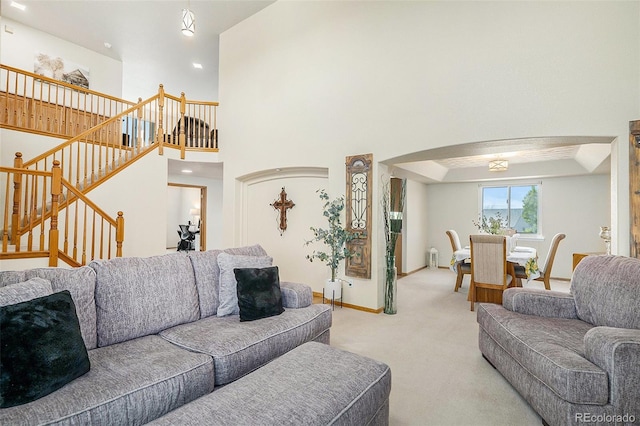 1325 Kingsfield St, Castle Rock, CO 80104 - living area with light colored carpet, stairway, arched walkways, and a high ceiling