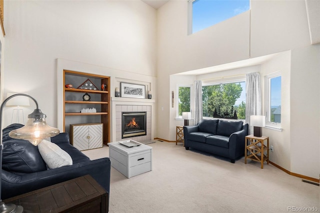 1325 Kingsfield St, Castle Rock, CO 80104 - living room featuring a towering ceiling, carpet floors, baseboards, and a tiled fireplace