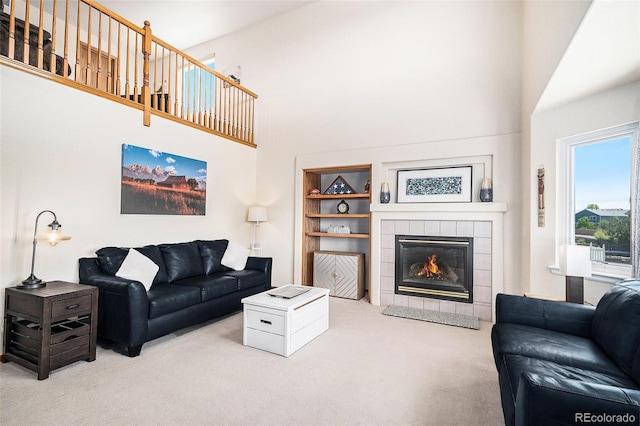 1325 Kingsfield St, Castle Rock, CO 80104 - living area with carpet flooring, a high ceiling, a fireplace, and built in features
