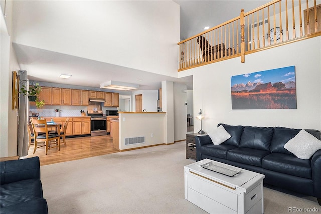1325 Kingsfield St, Castle Rock, CO 80104 - living area with a high ceiling, light colored carpet, baseboards, and recessed lighting