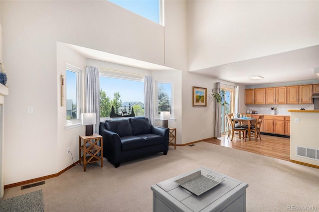 1325 Kingsfield St, Castle Rock, CO 80104 - living room with light colored carpet, a towering ceiling, and baseboards