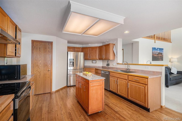 1325 Kingsfield St, Castle Rock, CO 80104 - kitchen with appliances with stainless steel finishes, a sink, a center island, light countertops, and a peninsula