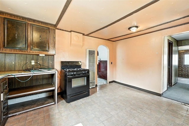 12 Marshall Pl, Longmont, CO 80504 - kitchen featuring black range with gas stovetop, a heating unit, arched walkways, light countertops, and dark brown cabinetry