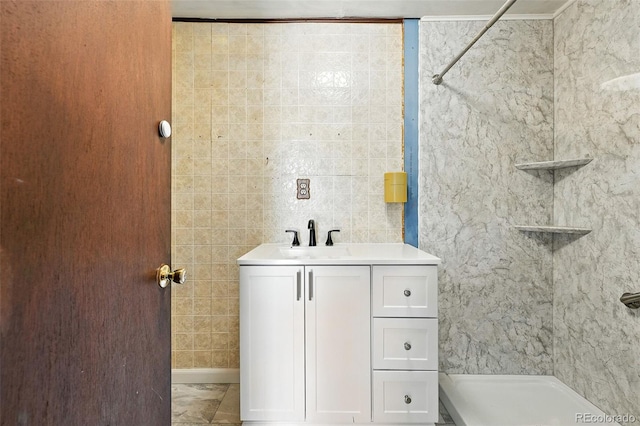12 Marshall Pl, Longmont, CO 80504 - bathroom featuring a shower, tile walls, and vanity