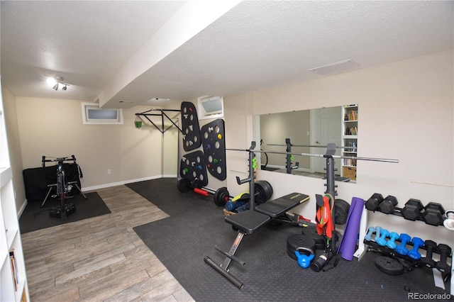 8229 Estes Ct, Arvada, CO 80005 - exercise area with wood finished floors and a textured ceiling