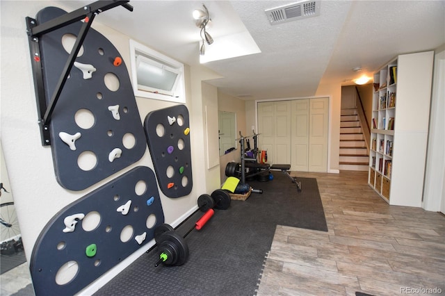 8229 Estes Ct, Arvada, CO 80005 - workout room featuring wood finished floors and a textured ceiling