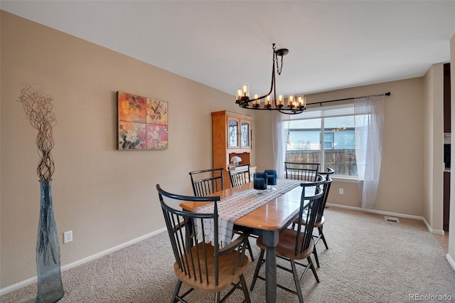 dining area featuring light carpet, visible vents, baseboards, and an inviting chandelier