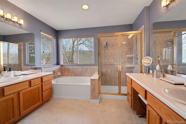 bathroom with two vanities, a sink, a stall shower, tile patterned floors, and a garden tub