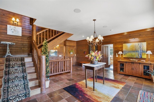 221 Columbine Pl, Woodland Park, CO 80863 - kitchen featuring wooden walls, a chandelier, stone finish floors, decorative light fixtures, and recessed lighting