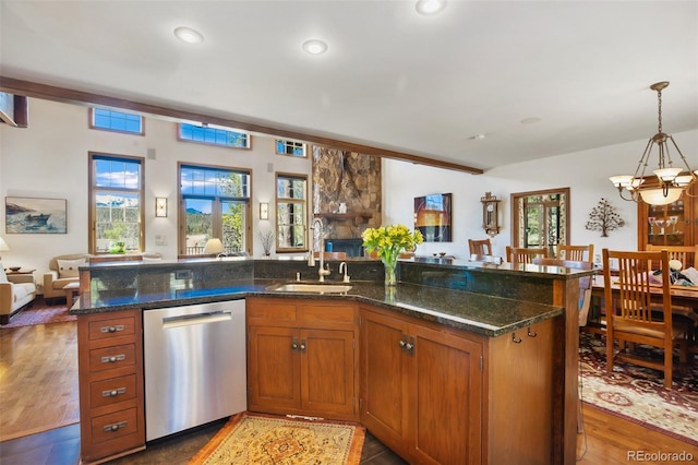 221 Columbine Pl, Woodland Park, CO 80863 - kitchen featuring dishwasher, open floor plan, a chandelier, brown cabinets, and dark stone counters
