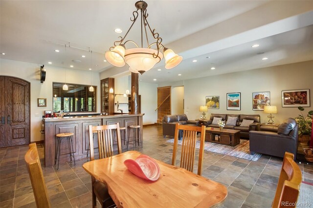 221 Columbine Pl, Woodland Park, CO 80863 - dining space with bar, recessed lighting, and dark stone finish floors