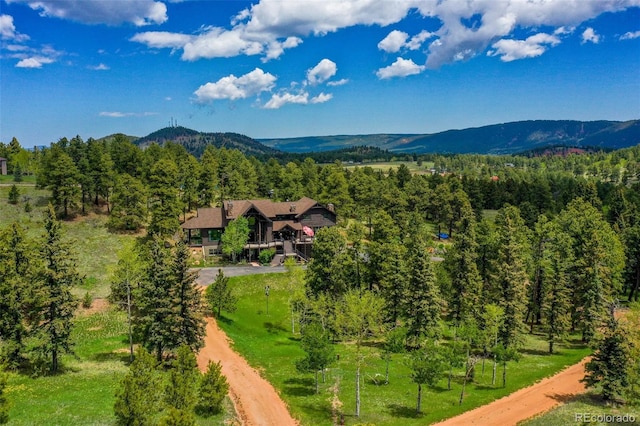 221 Columbine Pl, Woodland Park, CO 80863 - aerial view of property and surrounding area featuring a mountainous background and a heavily wooded area