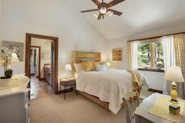 221 Columbine Pl, Woodland Park, CO 80863 - bedroom featuring high vaulted ceiling, connected bathroom, light carpet, and ceiling fan