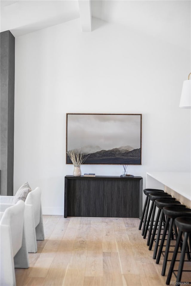 interior space featuring beamed ceiling and wood finished floors