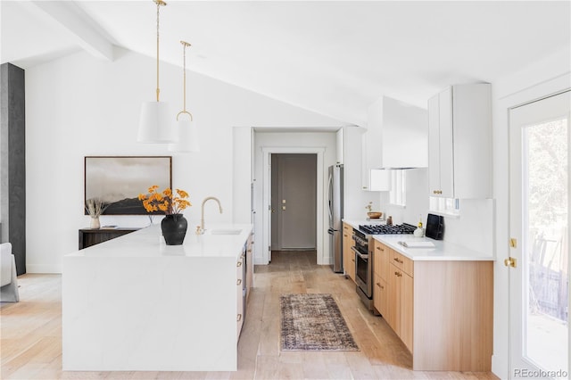 kitchen featuring stainless steel appliances, lofted ceiling with beams, light wood-style floors, a sink, and premium range hood