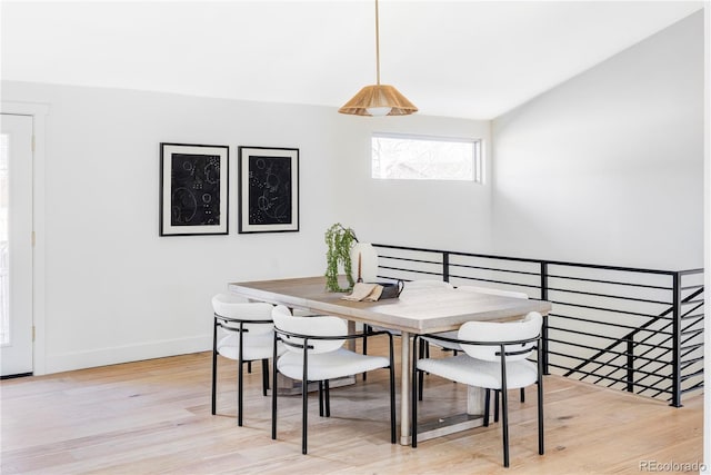 dining room with light wood-style floors and baseboards