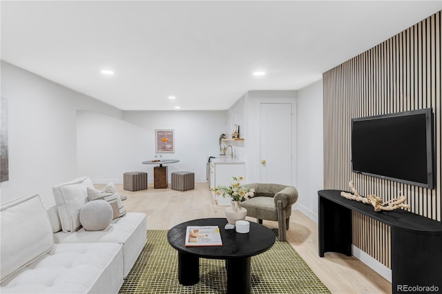 living room with recessed lighting, baseboards, and light wood finished floors