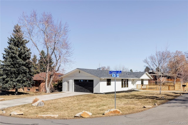 single story home featuring a garage, driveway, and a front yard