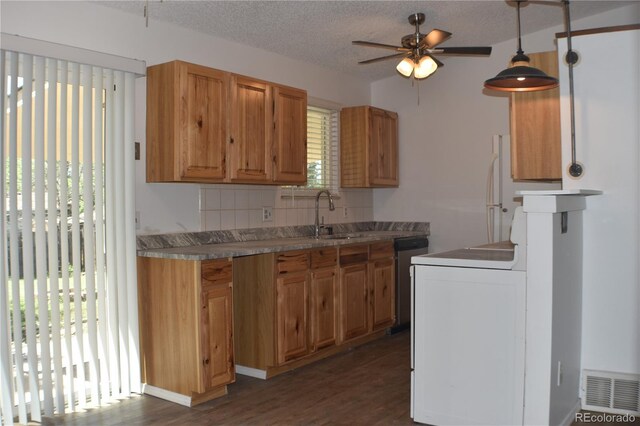 4585 Gatewood Dr, Colorado Springs, CO 80916 - kitchen featuring dishwashing machine, a ceiling fan, dark wood-type flooring, tasteful backsplash, and a textured ceiling