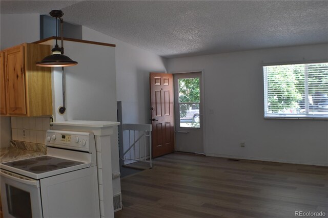 4585 Gatewood Dr, Colorado Springs, CO 80916 - kitchen featuring electric stove, a textured ceiling, wood finished floors, light countertops, and backsplash