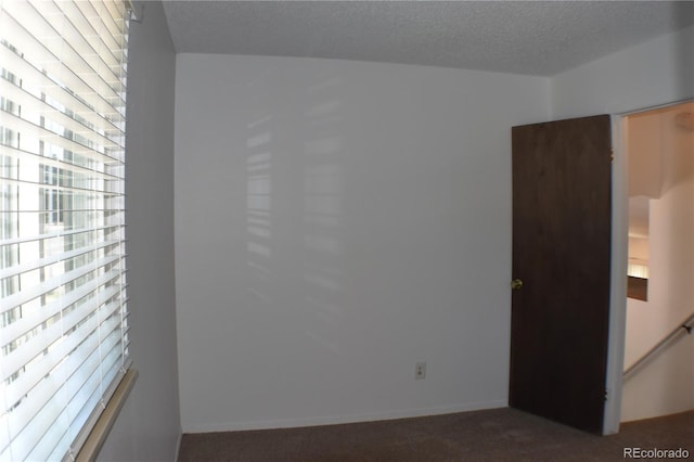 4585 Gatewood Dr, Colorado Springs, CO 80916 - spare room featuring dark carpet and a textured ceiling