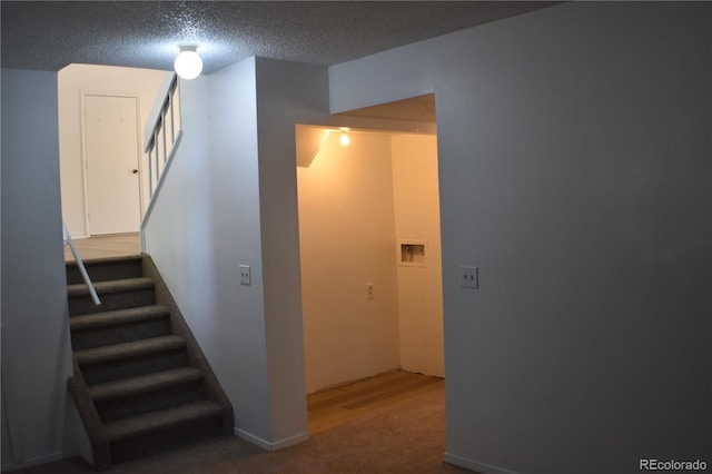4585 Gatewood Dr, Colorado Springs, CO 80916 - staircase with carpet floors and a textured ceiling