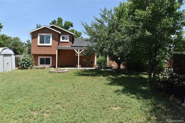 4585 Gatewood Dr, Colorado Springs, CO 80916 - rear view of house with a lawn, stucco siding, and a shed