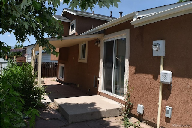 4585 Gatewood Dr, Colorado Springs, CO 80916 - view of side of property featuring stucco siding and a patio area