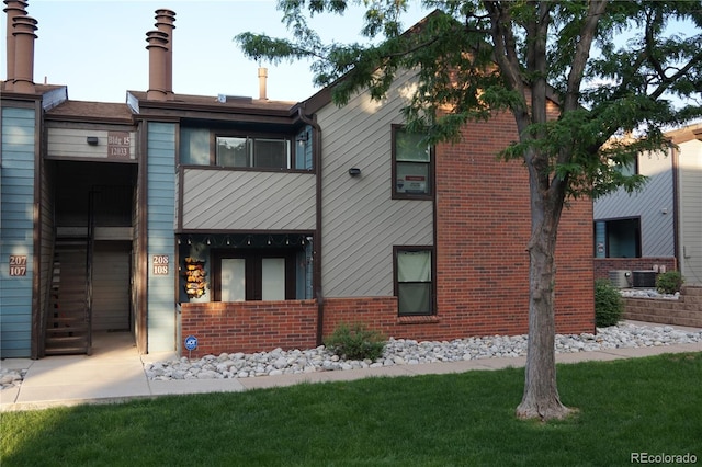 12033 E Harvard Ave Unit 208, Aurora, CO 80014 - view of front of home featuring brick siding and a front yard
