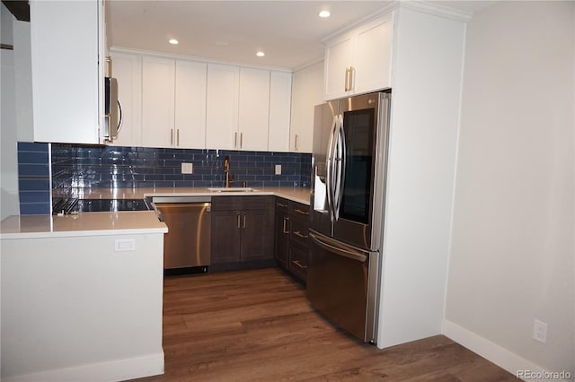 12033 E Harvard Ave Unit 208, Aurora, CO 80014 - kitchen featuring stainless steel appliances, wood finished floors, backsplash, light countertops, and recessed lighting