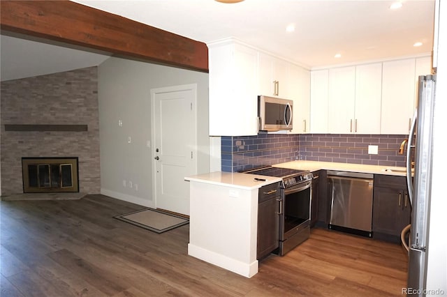 12033 E Harvard Ave Unit 208, Aurora, CO 80014 - kitchen featuring stainless steel appliances, tasteful backsplash, white cabinetry, wood finished floors, and light countertops