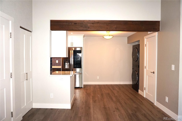 12033 E Harvard Ave Unit 208, Aurora, CO 80014 - kitchen featuring stainless steel refrigerator with ice dispenser, stacked washer / drying machine, dark wood-style flooring, white cabinetry, and light countertops