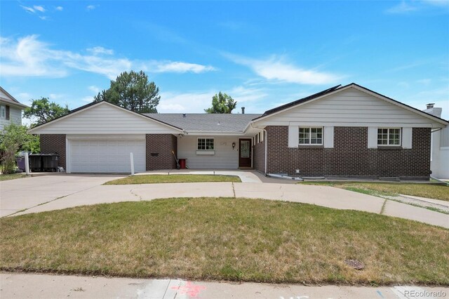 ranch-style house with a garage and a front lawn