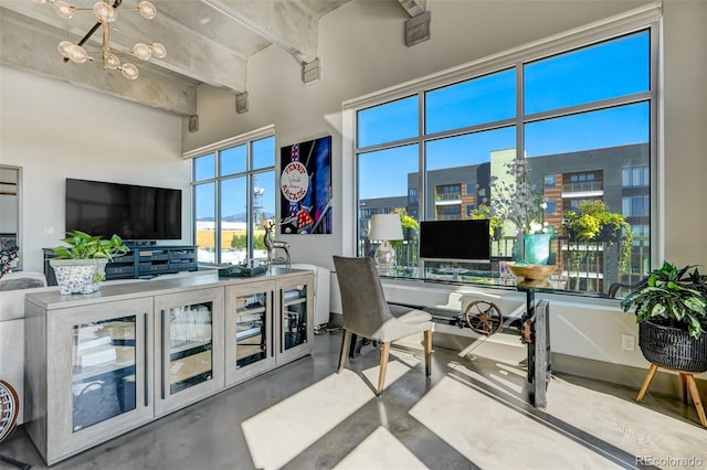 office space with concrete floors and a notable chandelier