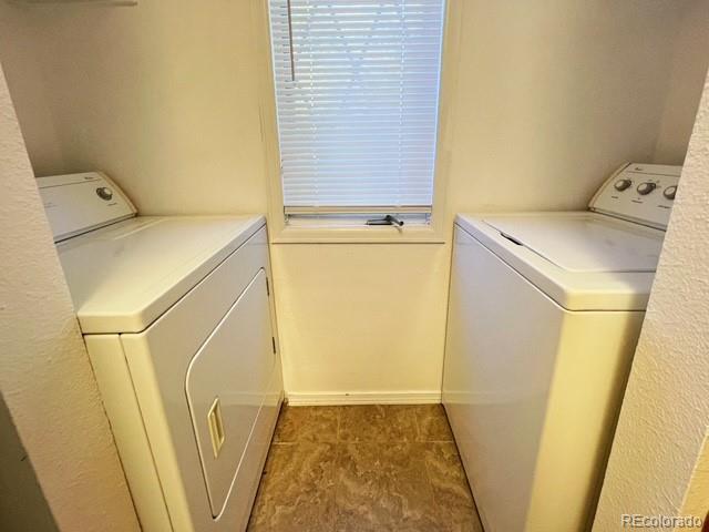 laundry room featuring separate washer and dryer and laundry area