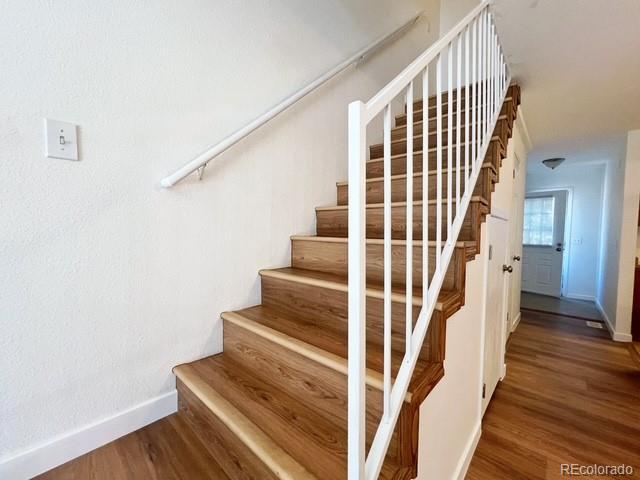 stairs featuring baseboards and wood finished floors