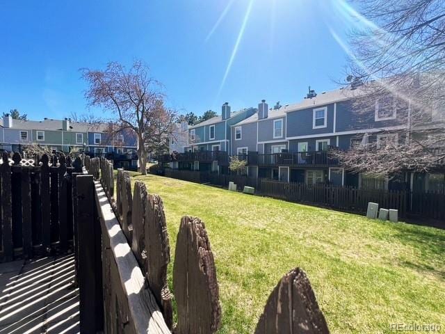 view of yard with a residential view and fence