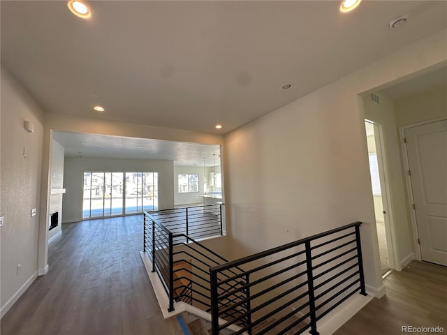 corridor with hardwood / wood-style flooring