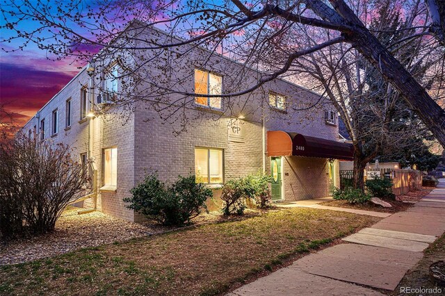 view of side of property featuring brick siding