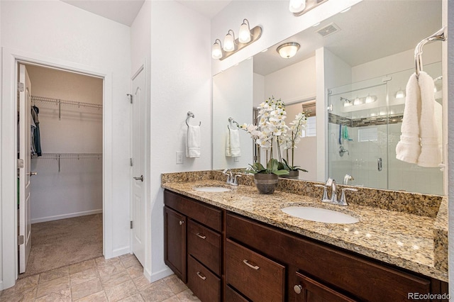 11791 Barrentine Loop, Parker, CO 80138 - bathroom featuring a stall shower, double vanity, a walk in closet, and baseboards