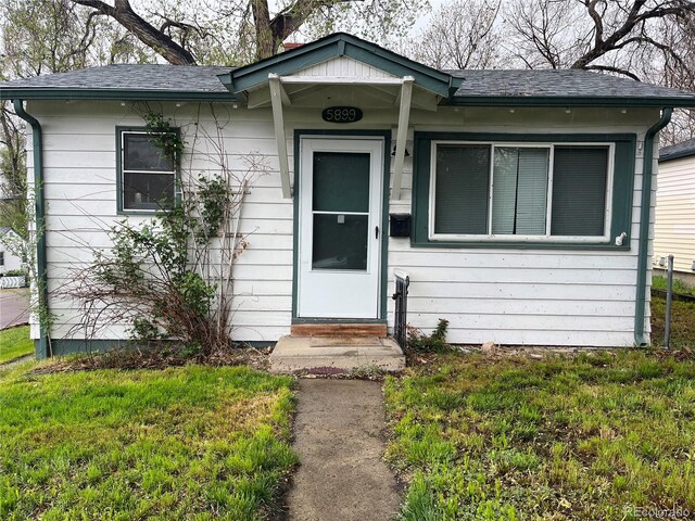 5899 Vance St, Arvada, CO 80003 - view of front of property featuring entry steps, a shingled roof, and a front yard