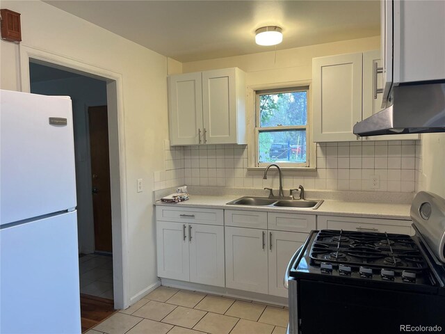 5899 Vance St, Arvada, CO 80003 - kitchen featuring freestanding refrigerator, range with gas cooktop, a sink, and light countertops