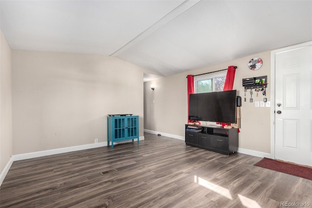 living room with vaulted ceiling, wood finished floors, visible vents, and baseboards